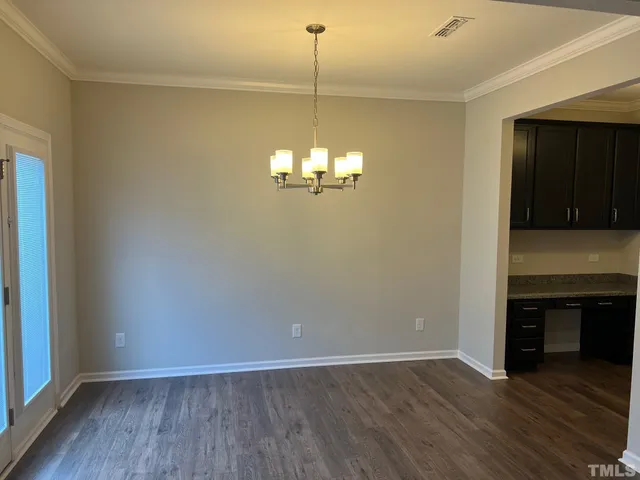a view of a room with wooden floor and fireplace