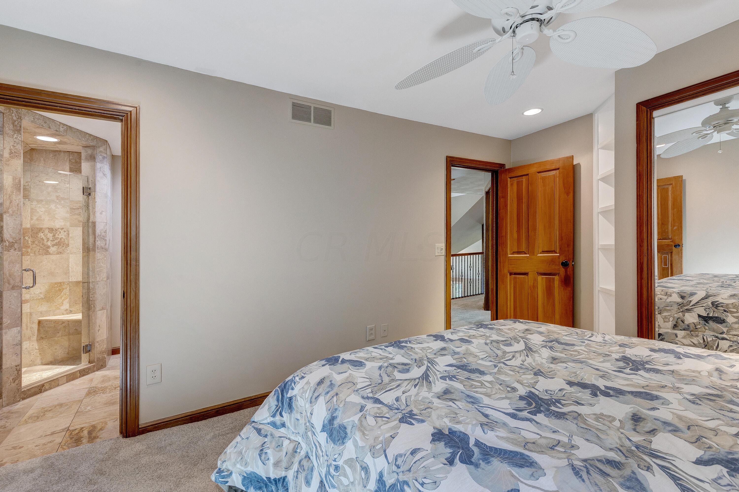 10640 Center Village Road Galena, OH 43021 - Photo 42 of 80 • New light sand carpet ~ 2022 • Tan painted walls • Angled ceiling • Ceiling fan • Can lighting • Bench seat • Closet with double sliding mirrored door • Corner display cabinets
