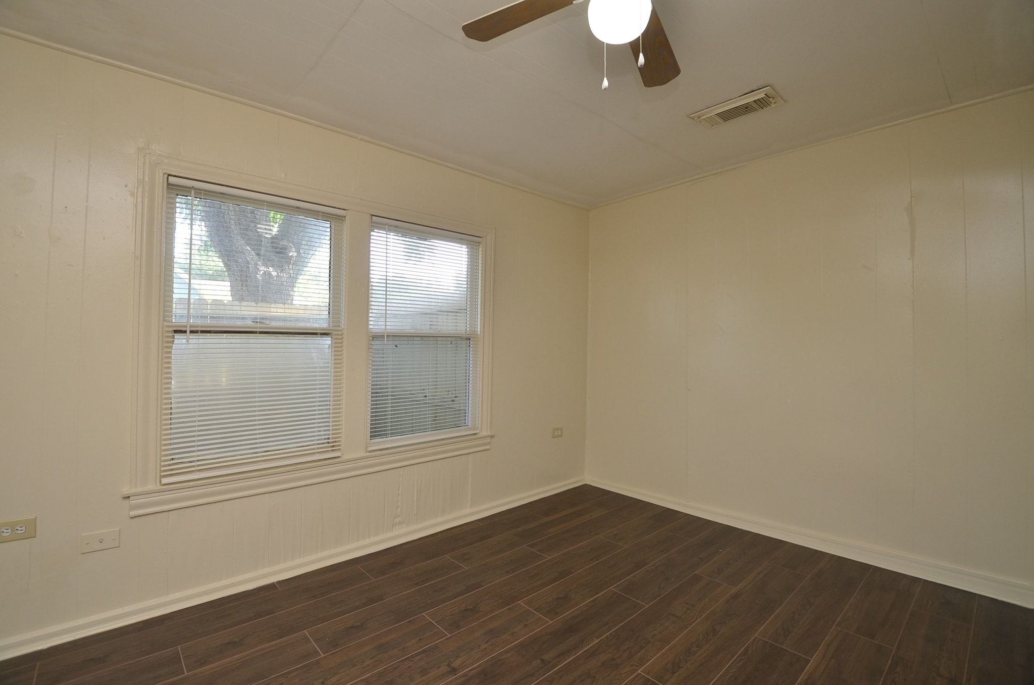 1600 5th Street Rosenberg, TX 77471 - Photo 14 of 24 Primary bedroom with updated flooring and ceiling fan.