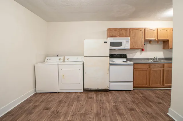 a utility room with sink dryer and washer