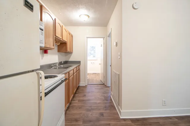 a kitchen with stainless steel appliances granite countertop a stove and a refrigerator