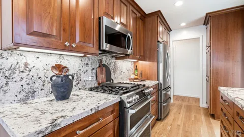 a kitchen with stainless steel appliances granite countertop a stove and a microwave