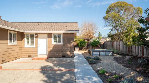 a view of a house with backyard and sitting area