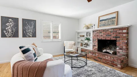a living room with furniture a rug and a fireplace