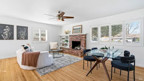a living room with furniture a window and a fireplace