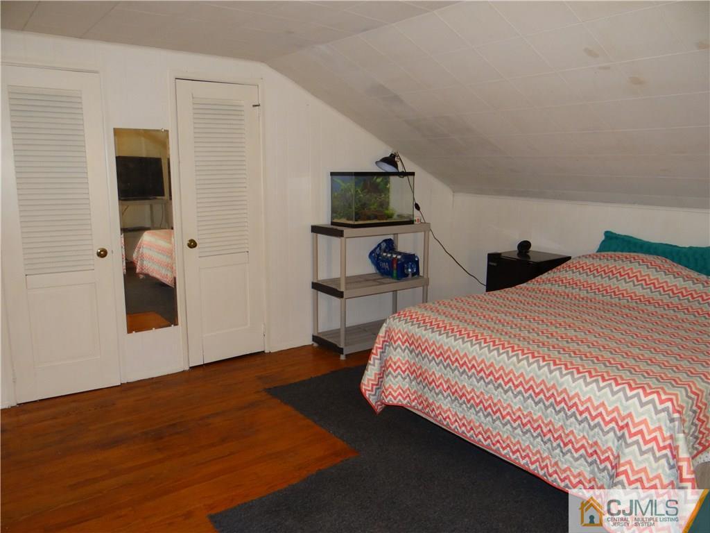9 Hill Road Edison, NJ 08817 - Photo 14 of 16 a bedroom with a bed and a flat screen tv