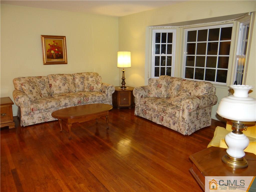 9 Hill Road Edison, NJ 08817 - Photo 5 of 16 a living room with furniture and a lamp