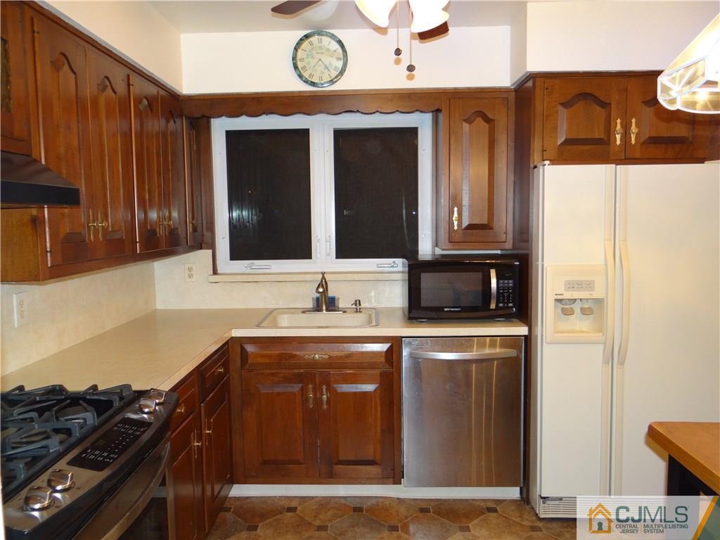 9 Hill Road Edison, NJ 08817 - Photo 7 of 16 a kitchen with stainless steel appliances granite countertop a stove and a sink