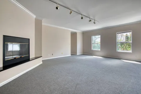 a view of a livingroom with an empty space and a window
