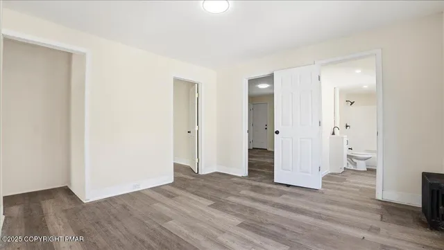 a kitchen with stainless steel appliances a refrigerator stove and white cabinets