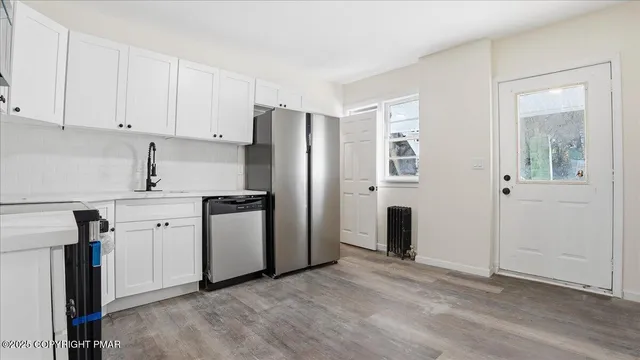 a kitchen with stainless steel appliances a stove a microwave and cabinets