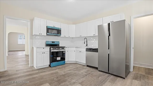 an empty room with wooden floor and a window