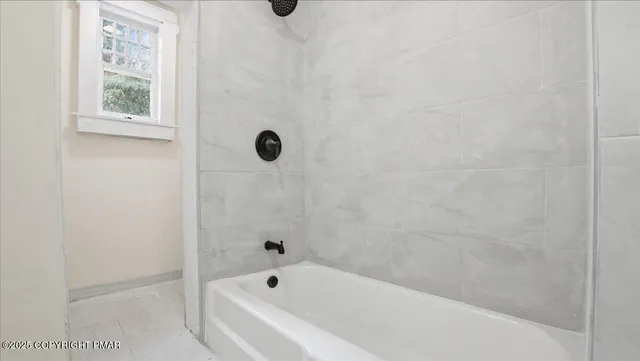 an empty room with wooden floor & closet and windows