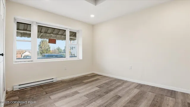 a view of empty room with a fireplace