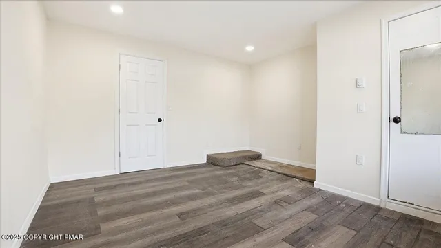a view of a balcony with wooden fence and floor