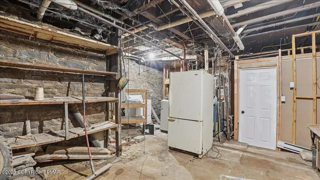 a picture of a bench in front of a wall