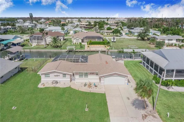an aerial view of residential houses with outdoor space and river