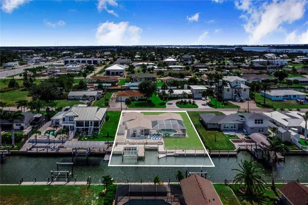 an aerial view of residential houses with outdoor space and river