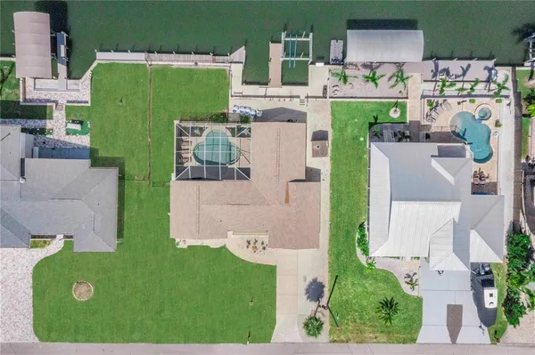an aerial view of a house with outdoor space and car parked