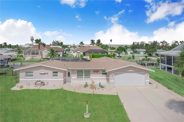 a view of a patio with a table chairs and a backyard