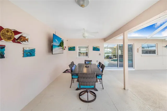 a dining room with furniture and a floor to ceiling window