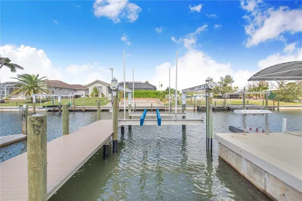 a living room with furniture a flat screen tv and a floor to ceiling window