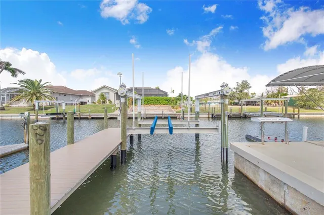 a living room with furniture a flat screen tv and a floor to ceiling window
