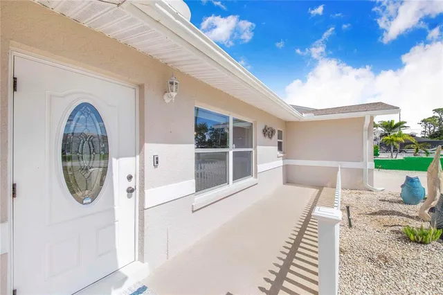 a living room with stainless steel appliances kitchen island a flat screen tv and a dresser
