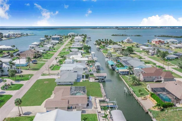 an aerial view of a house with a garden and lake view