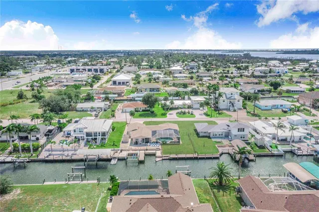 an aerial view of residential houses with outdoor space and river
