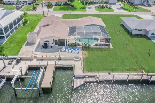 an aerial view of a house with a backyard space and sitting space