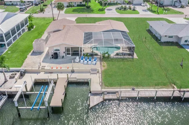 an aerial view of a house with a backyard space and sitting space