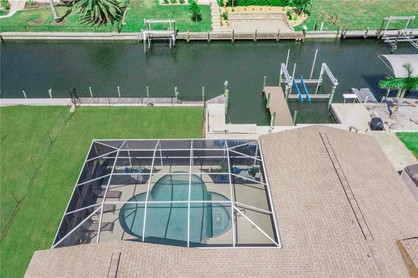 an aerial view of a house with outdoor space and car parked