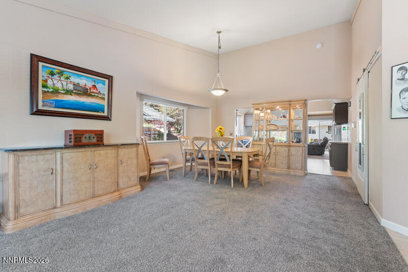 675 College Drive Reno, NV 89503 - Photo 3 of 30 a living room with furniture a dining table and chairs