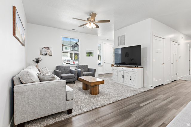 4735 Alder Drive, Unit F101 Mapleton, UT 84664 - Photo 5 of 30 Living room with light wood-type flooring and ceiling fan