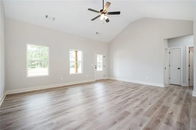 wooden floor in an empty room with a window