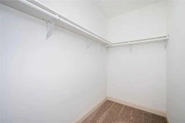 a bathroom with a granite countertop toilet sink and mirror