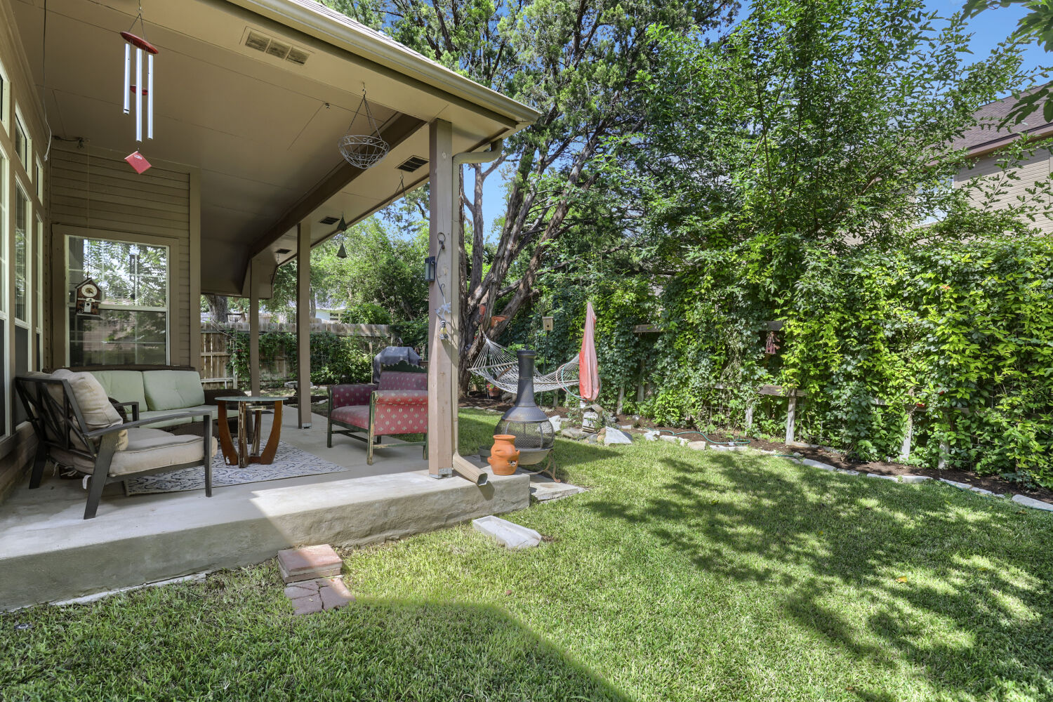206 Gann Street Georgetown, TX 78626 - Photo 18 of 19 a view of a chair and tables in the back yard of the house