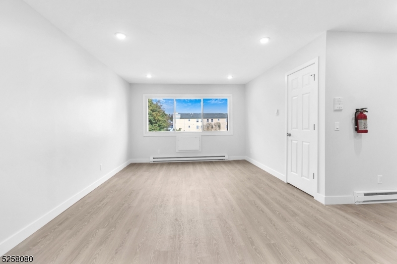 557 South Broad Street, Unit B1 Elizabeth, NJ 07202 - Photo 3 of 6 a view of a room with wooden floor and window