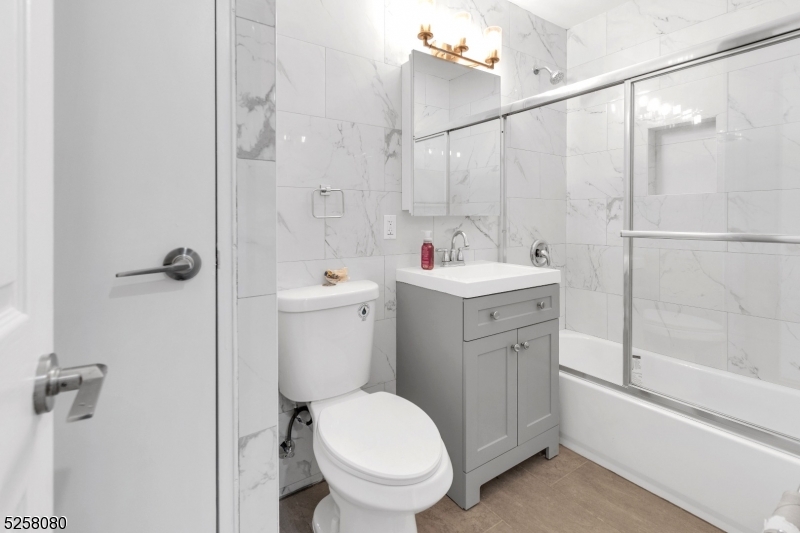 557 South Broad Street, Unit B1 Elizabeth, NJ 07202 - Photo 4 of 6 a bathroom with a toilet sink and shower