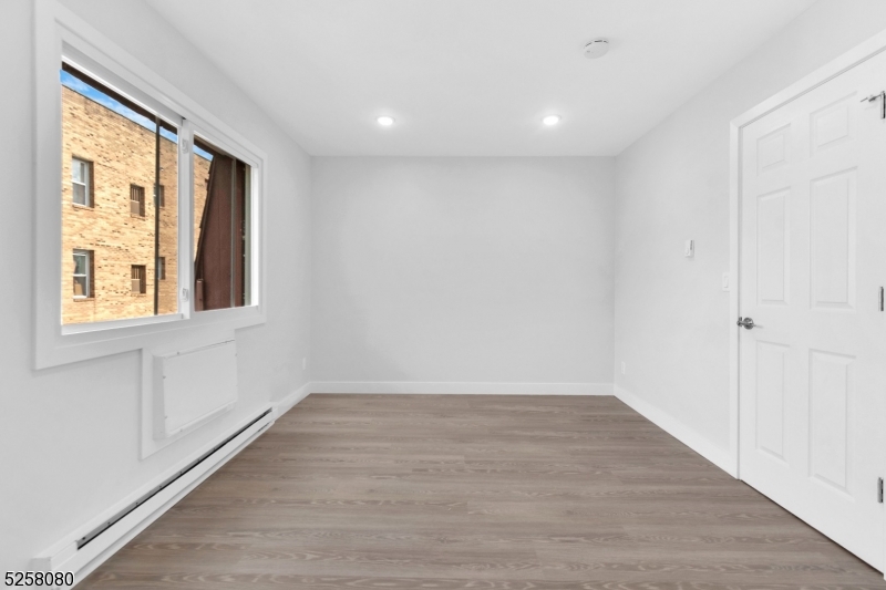 557 South Broad Street, Unit B1 Elizabeth, NJ 07202 - Photo 5 of 6 a view of an empty room with wooden floor and a window