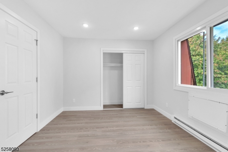 557 South Broad Street, Unit B1 Elizabeth, NJ 07202 - Photo 6 of 6 a view of an empty room with wooden floor and a window