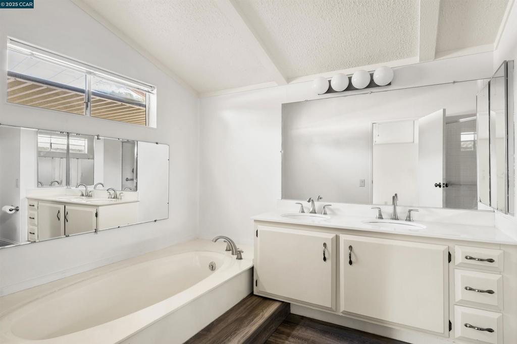 1201 Monument Boulevard Concord, CA 94520 - Photo 15 of 23 a bathroom with a tub a sink and mirror