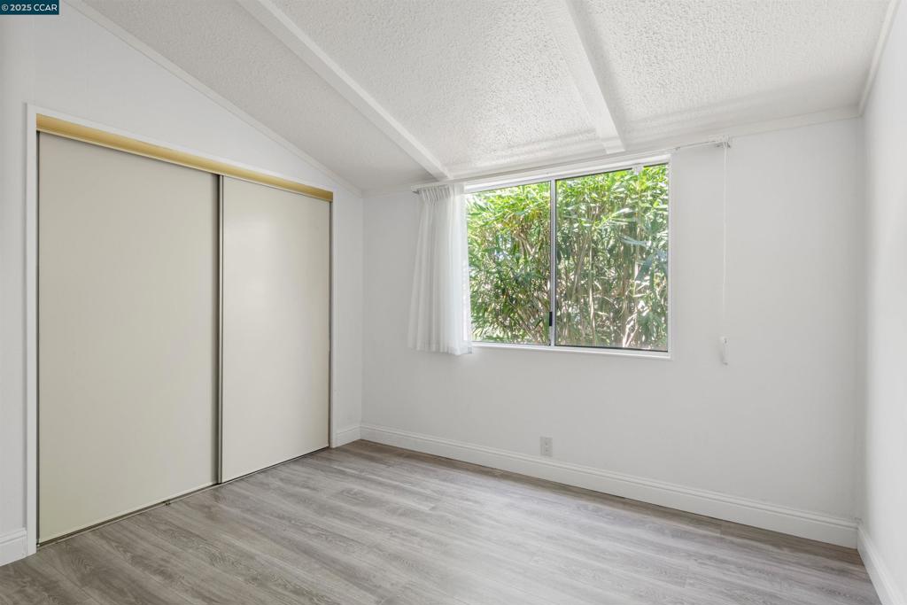 1201 Monument Boulevard Concord, CA 94520 - Photo 19 of 23 an empty room with wooden floor and windows