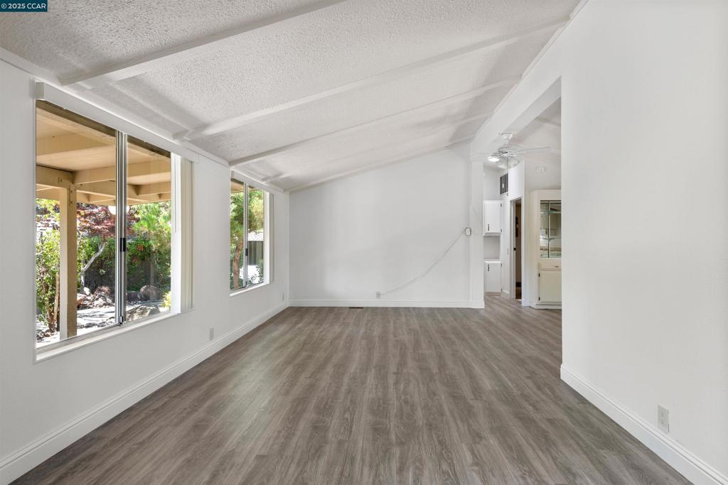 1201 Monument Boulevard Concord, CA 94520 - Photo 3 of 23 an empty room with wooden floor and windows