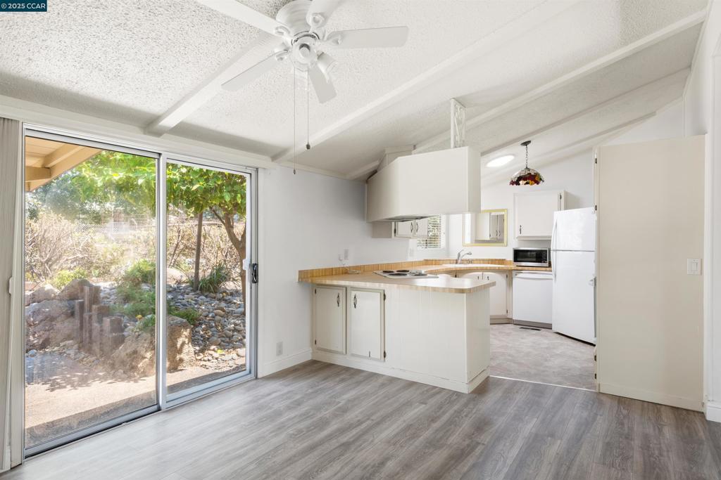1201 Monument Boulevard Concord, CA 94520 - Photo 7 of 23 a kitchen with a stove a sink and a refrigerator