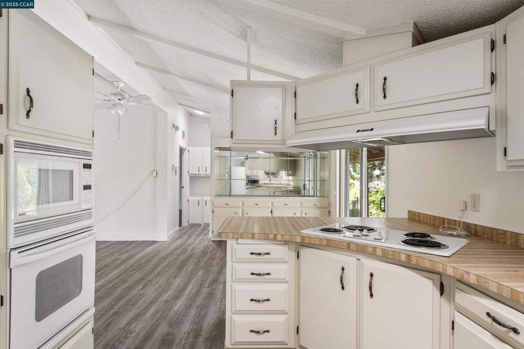 1201 Monument Boulevard Concord, CA 94520 - Photo 10 of 23 a kitchen with granite countertop white cabinets and white appliances