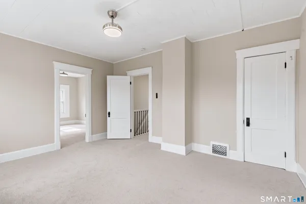 a view of empty room with ceiling fan