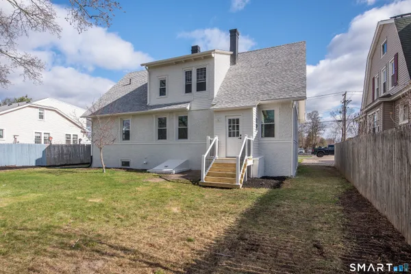a view of a house with backyard porch and furniture