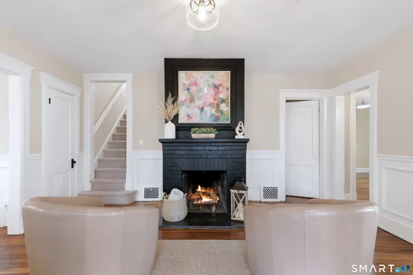 a living room with furniture a fireplace and a window